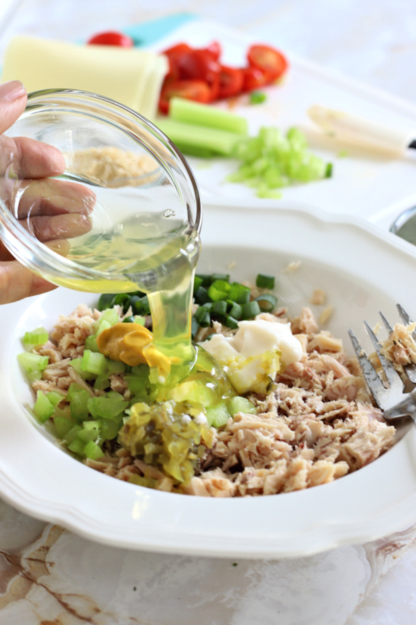 Adding an egg white to the ingredients for a classic tuna melt sandwich on a bun or English muffin.