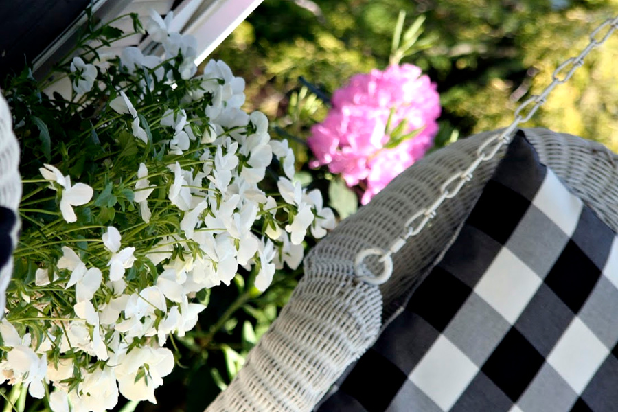 Sprucing up and decorating with accessories, flowers and garden plants getting ready for leisurely  spring and summertime front porch living.