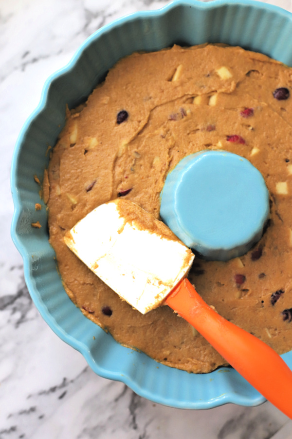 Spreading all the flavors of Thanksgiving cake batter in Bundt pan.