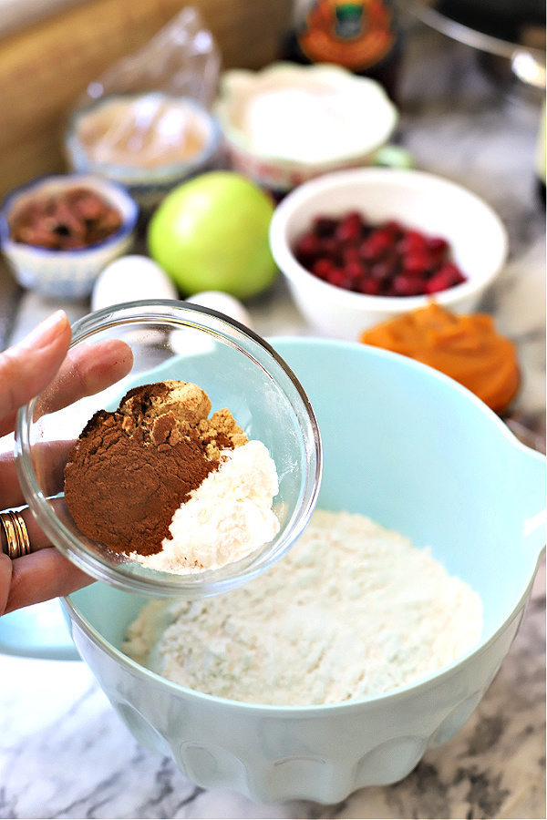 Adding spices to ingredients for all the flavors Thanksgiving Bundt cake