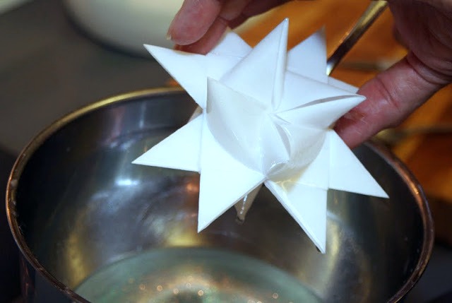 Tutorial for dipping folded paper German Stars in wax to preserve and protect from outdoor elements.