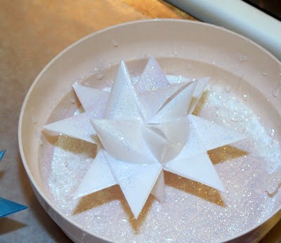 Tutorial for dipping folded paper German Stars in wax to preserve and protect from outdoor elements.