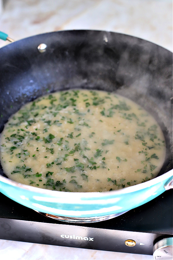 Chicken francese lemon sauce in skillet.