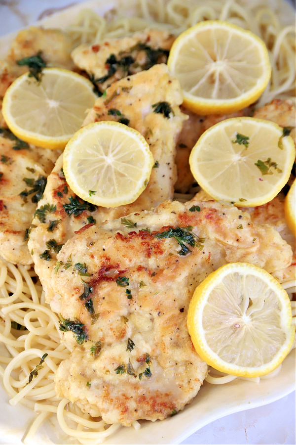 Lemony chicken francese over spaghetti pasta.