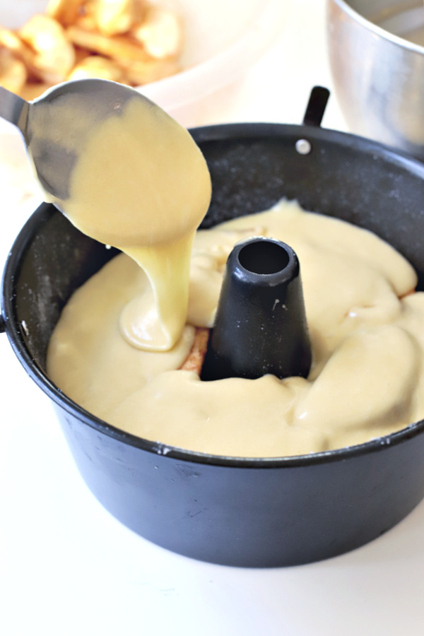 Adding the remaining Jewish apple cake batter over layer of apples