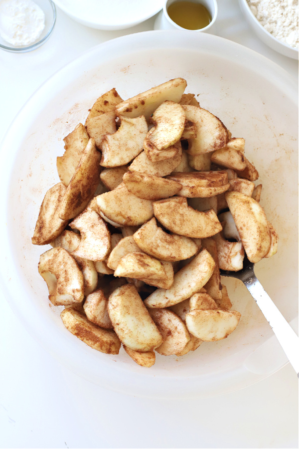 Tossing sugar, cinnamon and apples for Jewish apple cake