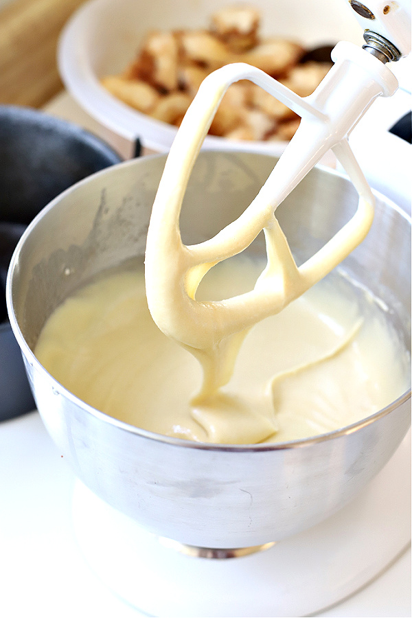 Large mixer combining ingredients for Jewish apple cake