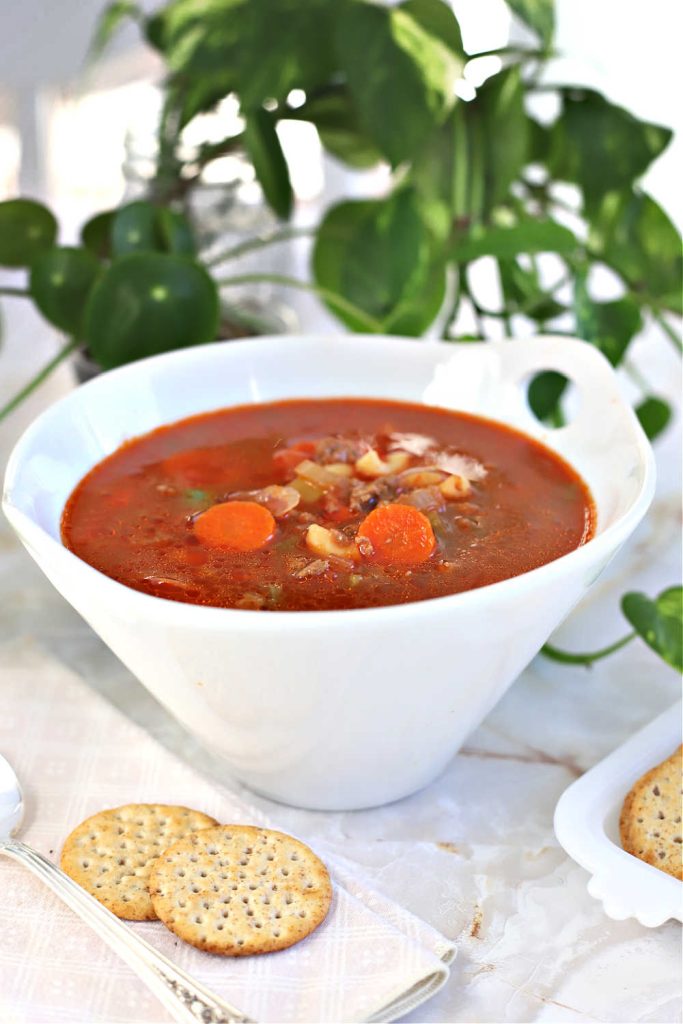 A bowl of hot homemade hamburger barley vegetable soup.