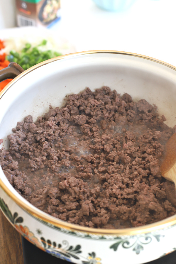 Browning the ground beef for hamburger barley vegetable soup.