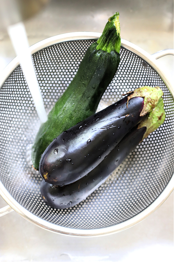 rinsing fresh eggplant and zucchini for grilling