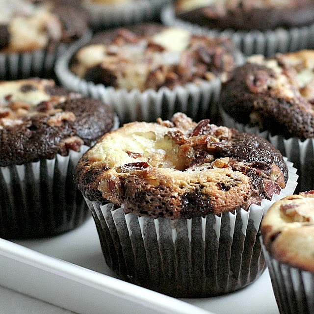 Moist and chocolaty, black bottom cups are rich little cupcakes with a cream cheese & chocolate chip filling and topped with sugar and pecans.