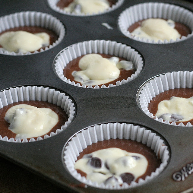 Moist and chocolaty, black bottom cups are rich little cupcakes with a cream cheese & chocolate chip filling and topped with sugar and pecans.