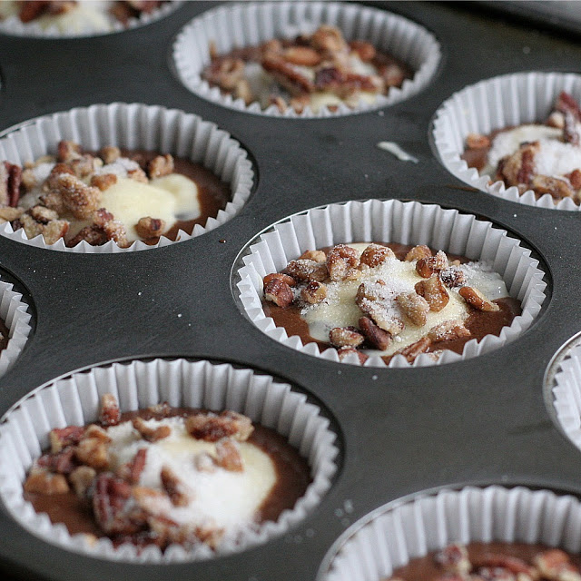 Moist and chocolaty, black bottom cups are rich little cupcakes with a cream cheese & chocolate chip filling and topped with sugar and pecans.