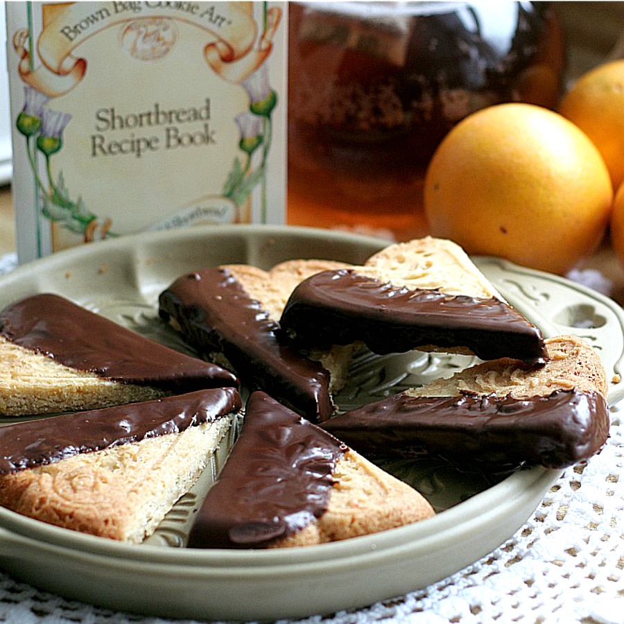 Easy recipe for chocolate dipped, orange spice shortbread. Delicious and beautiful with or without sprinkled nuts to enjoy with coffee or tea. Lovely addition to the holiday cookie tray and wonderful as homemade gift from the kitchen.