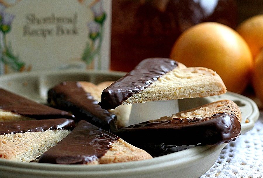 Easy recipe for chocolate dipped, orange spice shortbread. Delicious and beautiful with or without sprinkled nuts to enjoy with coffee or tea. Lovely addition to the holiday cookie tray and wonderful as homemade gift from the kitchen.