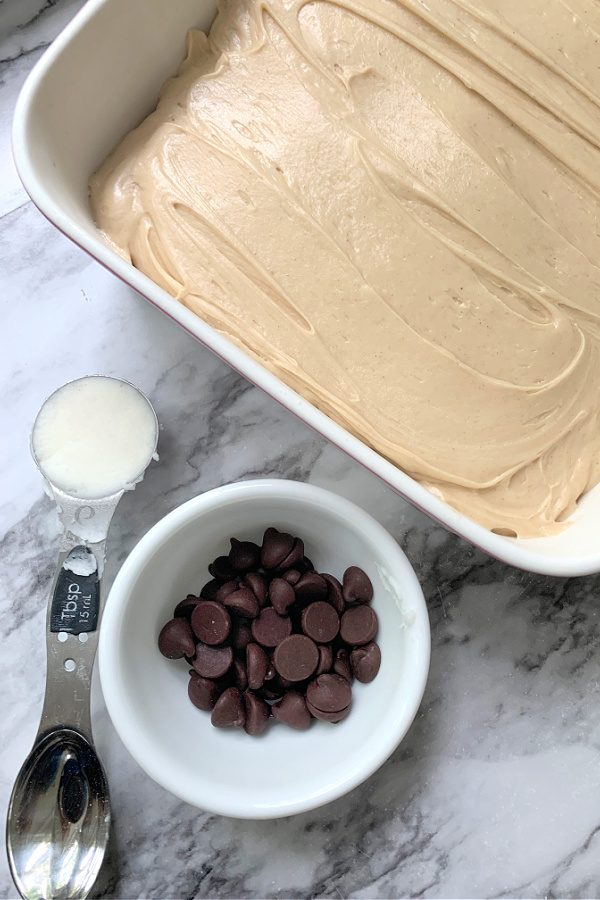 Melting chocolate with shortening for topping Peanut Butter Frosted Brownies recipe.