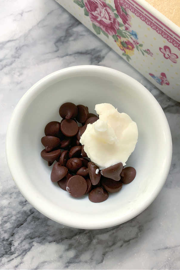 Melting chocolate with shortening for topping Peanut Butter Frosted Brownies recipe.