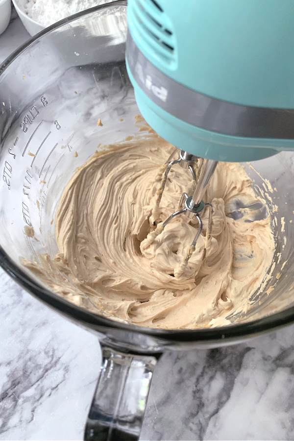 Creaming together butter and butter for making Peanut Butter Frosted Brownies recipe.