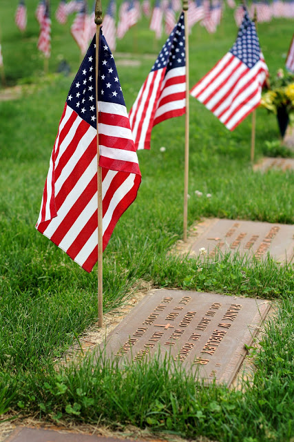 Remembering Memorial day and those who served including World War 1 and World War 2 with American flags decorating each grave at Brigadier General William C. Doyle Veterans Memorial Cemetery.