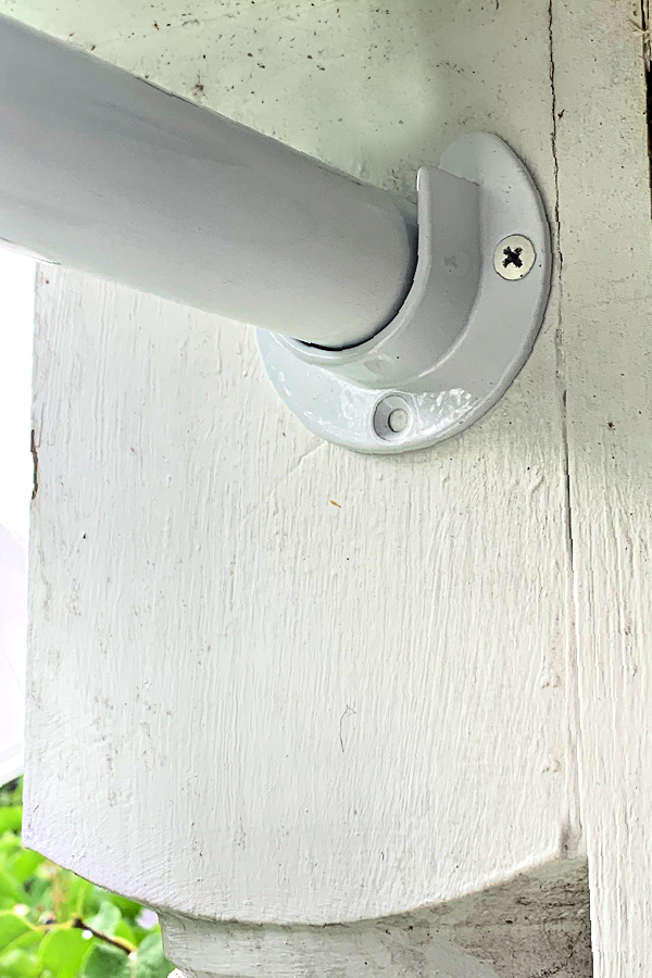 closet pole and sockets for hanging repurposed curtains on porch