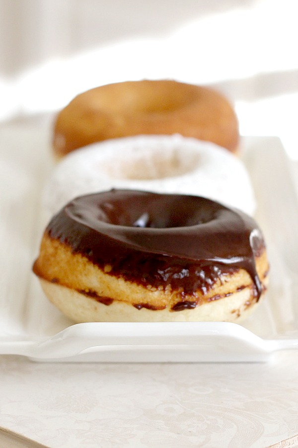 Debate remains as to how to spell these circular wonders of dough with the hole in the center. Spell "donut" or "doughnut", there is no debate about enjoying homemade, baked donuts. The only decision is whether to choose frosted, rolled in cinnamon sugar, confectioners' sugar or a perfectly plain doughnut. Skip the frying with this easy baked version.