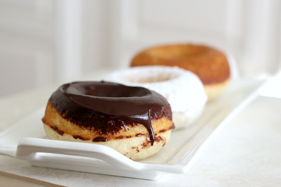 Debate remains as to how to spell these circular wonders of dough with the hole in the center. Spell "donut" or "doughnut", there is no debate about enjoying homemade, baked donuts. The only decision is whether to choose frosted, rolled in cinnamon sugar, confectioners' sugar or a perfectly plain doughnut. Skip the frying with this easy baked version.