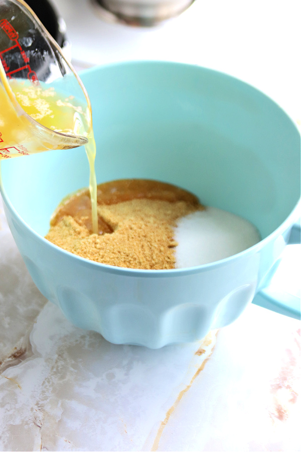 Preparing graham cracker crumb crust for triple lemon cheesecake.