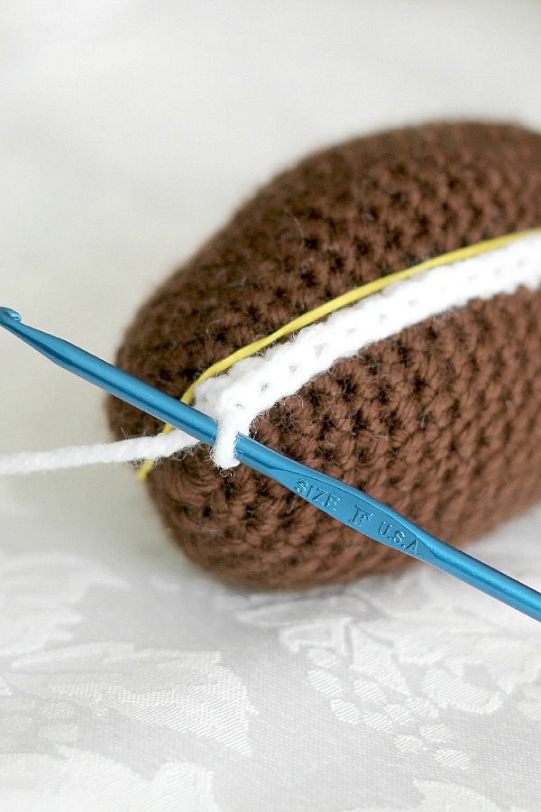 Peek inside this sweet crocheted chocolate diorama Easter egg decorated with faux frosting and embroidered scrolls. Cute pattern for holiday décor tablescapes or filling Easter baskets.