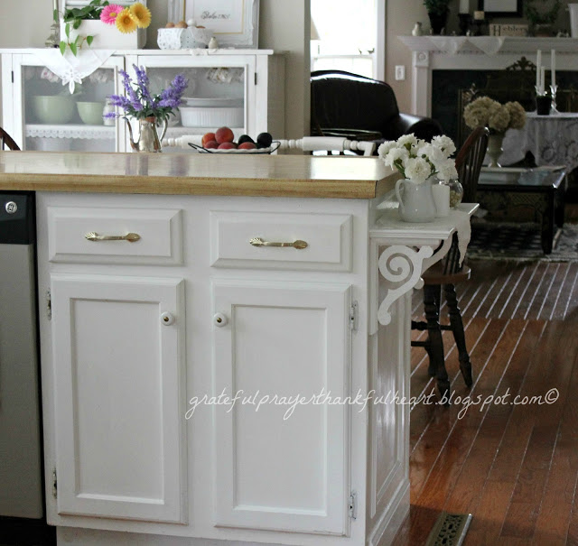 An easy DIY kitchen shelf adds a decorative and functional element to cabinets and counter top giving extra space for serving.