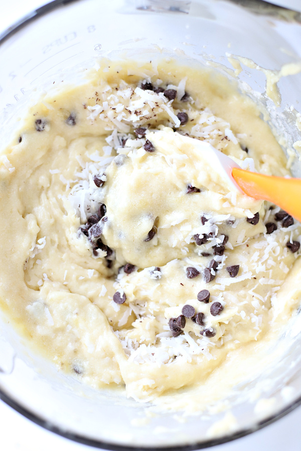 Adding chocolate chips to the coconut banana quick bread batter.