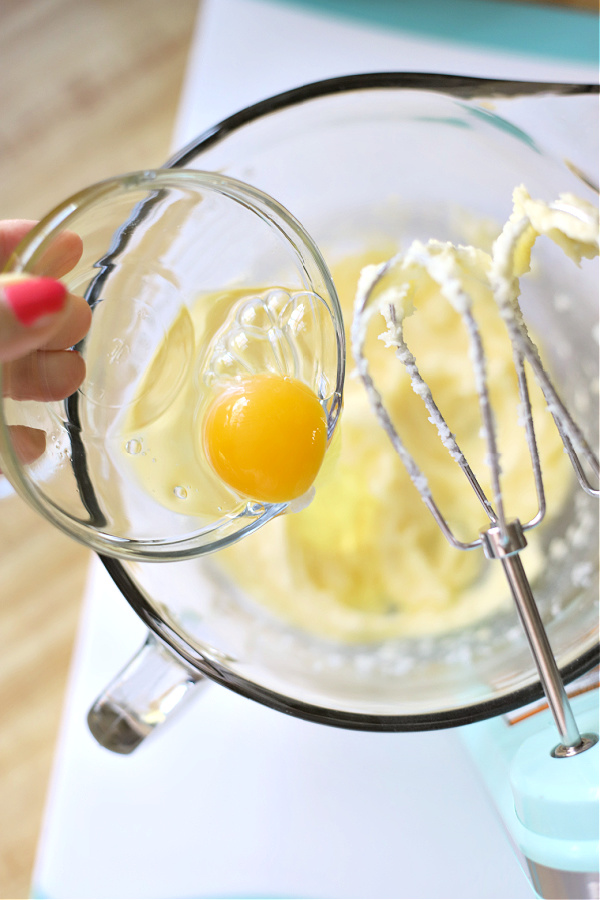 Adding eggs to the coconut banana quick bread batter.