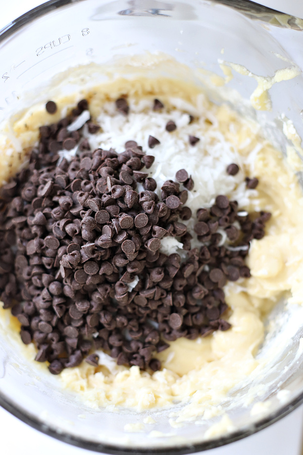 Adding chocolate chips to the coconut banana quick bread batter.