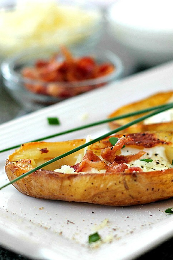 Oven crisped Potato skins make an easy and delicious appetizer. Baked until crisp and loaded with bacon, cheese, green onions or sour cream.