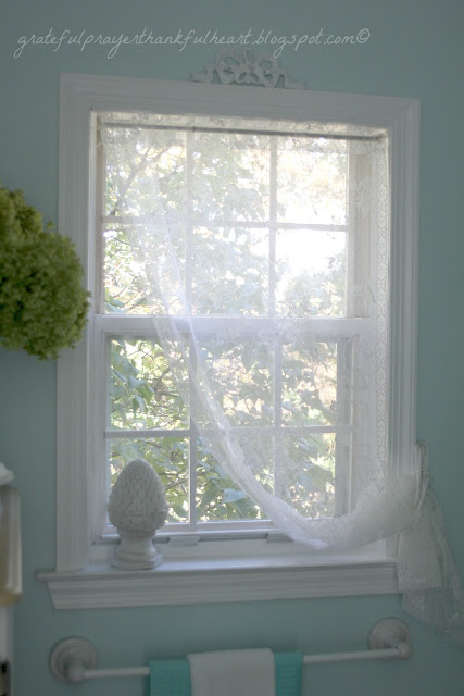 Easy DIY Powder Room redo in Aqua frost paint color with pretty white accents found around the house and re-purposed to create a lovely room on a budget.