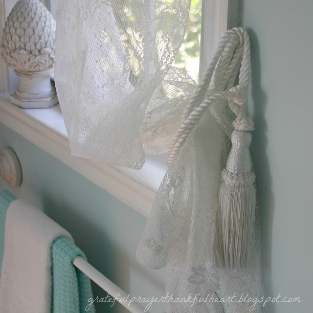 Easy DIY Powder Room redo in Aqua frost paint color with pretty white accents found around the house and re-purposed to create a lovely room on a budget.