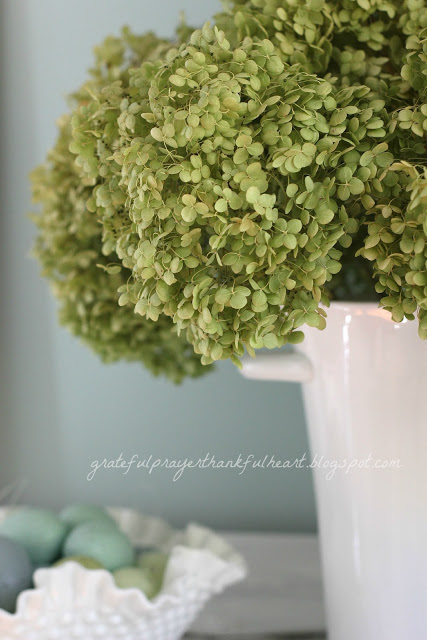 Easy DIY Powder Room redo in Aqua frost paint color with pretty white accents found around the house and re-purposed to create a lovely room on a budget.