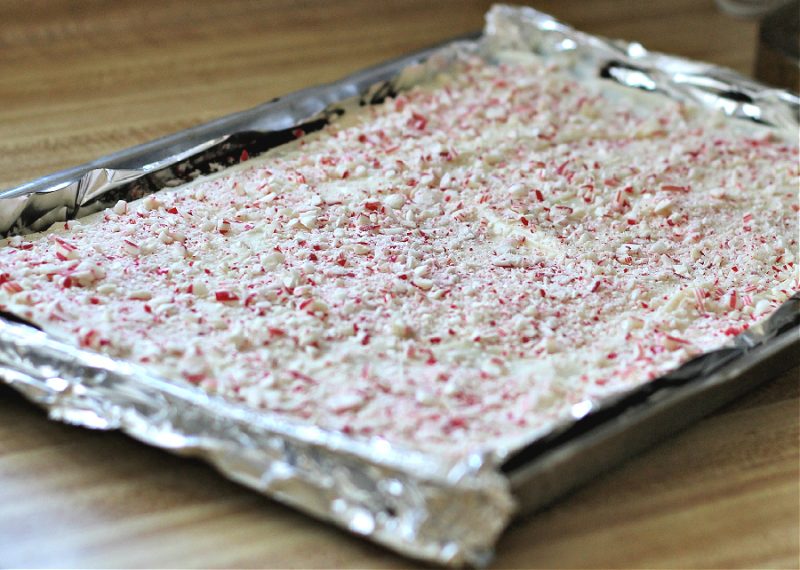 Chocolate Peppermint Bark, an easy recipe of layered white & milk chocolate flavored with peppermint and topped with crushed candy canes.