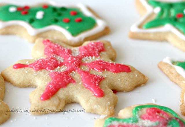 Frosted Sugar Cookies are festive and fun for holidays or birthdays. Easy recipe for cookies and frosting to make the prettiest and tastiest cookies!