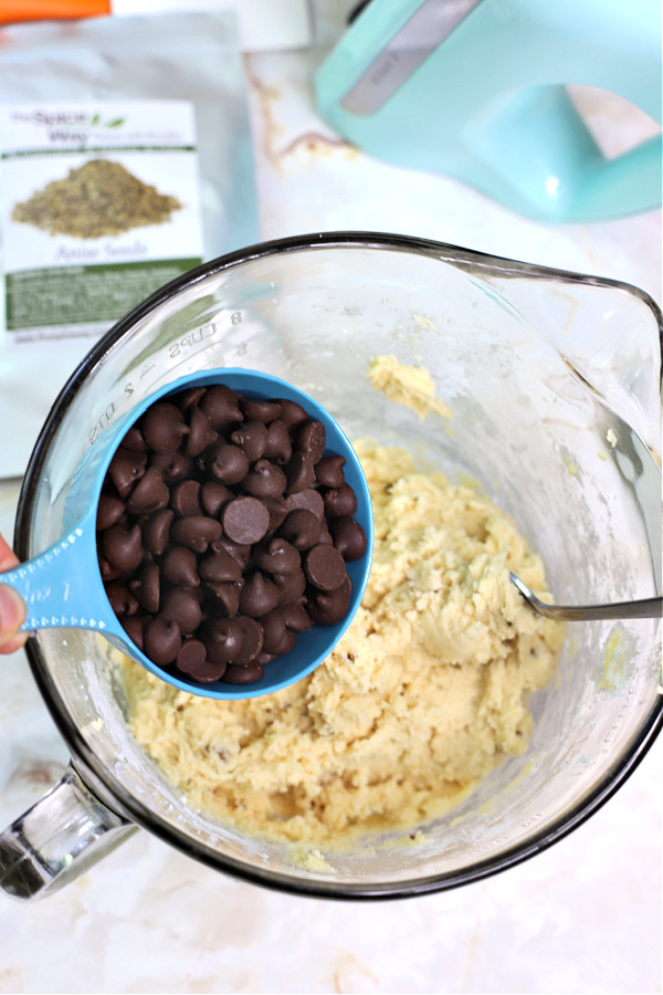 Adding chips to the batter for chocolate anise biscotti