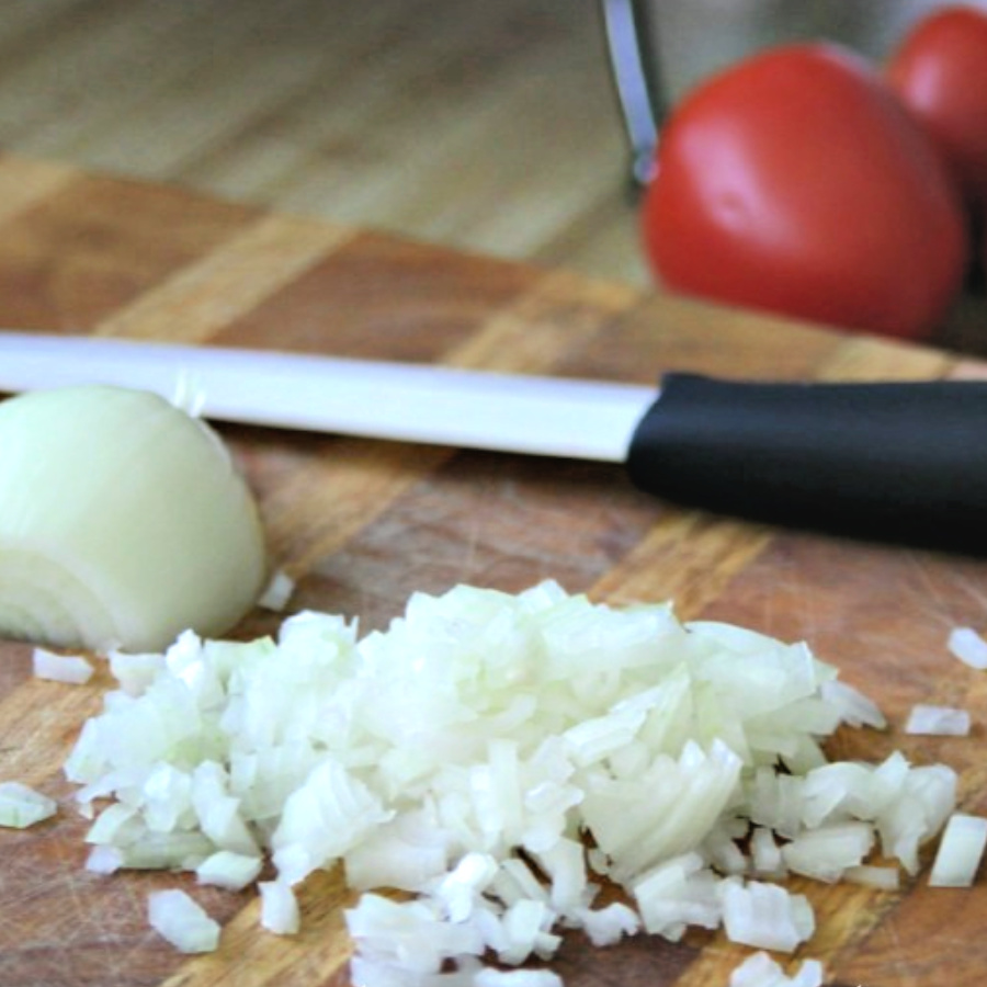 Easy recipe for bacon tomato jam, of sauteed bacon and sweet onions. A savory condiment with a little kick perfect for burgers, eggs and veggies.