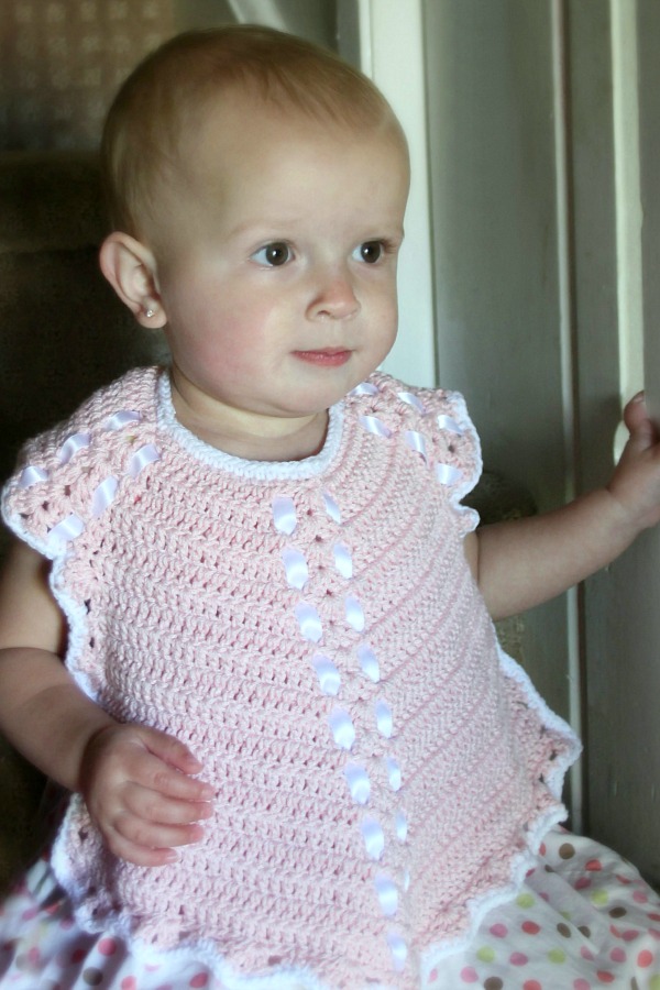 Sweet crochet baby bib is adapted from a vintage pattern and perfect for a toddler. Almost too pretty to use as a bib but adorable to dress up an outfit.