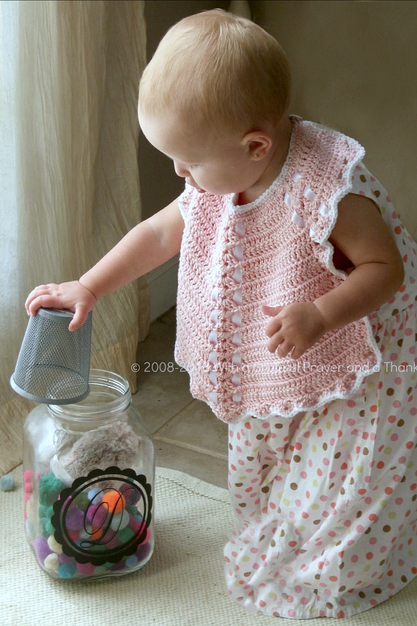 Sweet crochet baby bib is adapted from a vintage pattern and perfect for a toddler. Almost too pretty to use as a bib but adorable to dress up an outfit.