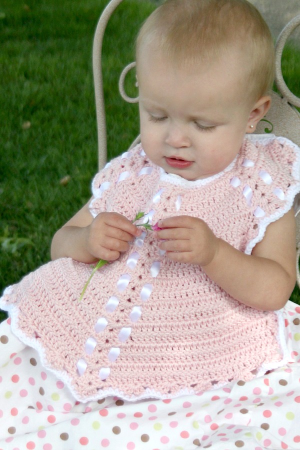 Sweet crochet baby bib is adapted from a vintage pattern and perfect for a toddler. Almost too pretty to use as a bib but adorable to dress up an outfit.