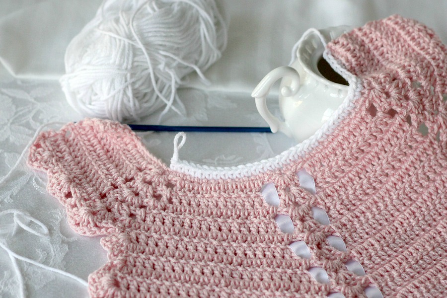 Sweet crochet baby bib is adapted from a vintage pattern and perfect for a toddler. Almost too pretty to use as a bib but adorable to dress up an outfit.