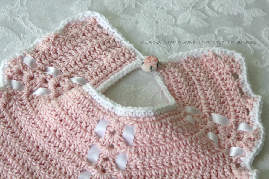 Sweet crochet baby bib is adapted from a vintage pattern and perfect for a toddler. Almost too pretty to use as a bib but adorable to dress up an outfit.