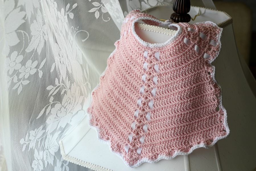 Sweet crochet baby bib is adapted from a vintage pattern and perfect for a toddler. Almost too pretty to use as a bib but adorable to dress up an outfit.