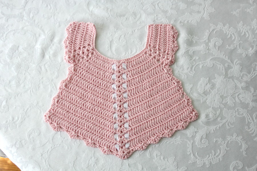 Sweet crochet baby bib is adapted from a vintage pattern and perfect for a toddler. Almost too pretty to use as a bib but adorable to dress up an outfit.