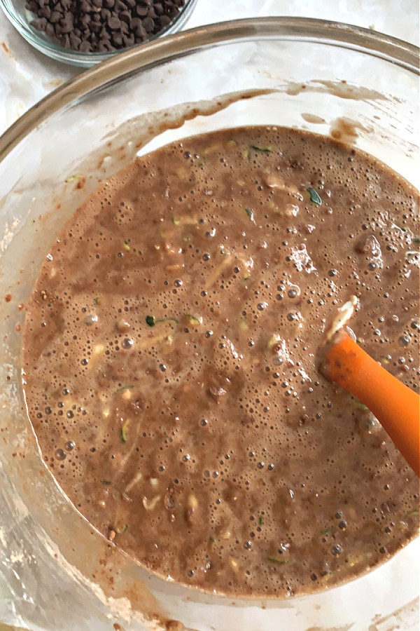 Adding dry ingredients for making the batter for cream cheese chocolate zucchini bread