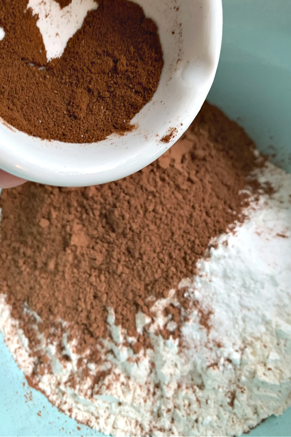 adding cocoa powder and espresso to make the batter for cream cheese chocolate zucchini bread