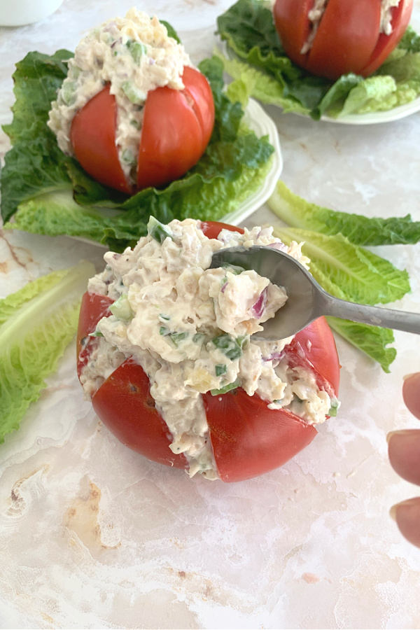 Use fresh garden tomatoes for creamy chicken stuffed tomatoes filled with fresh herbs, pineapple and cream cheese for a light summer lunch.